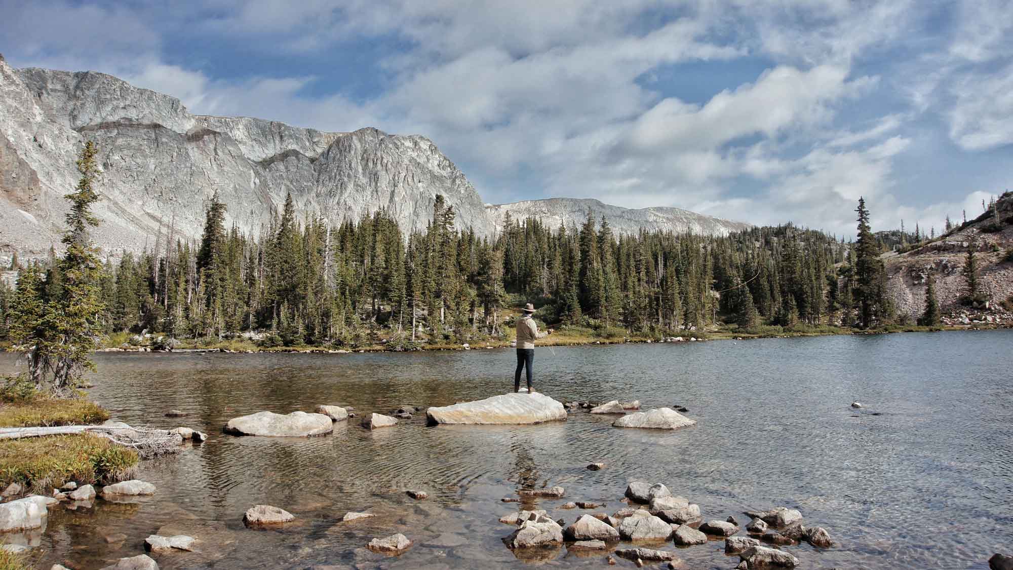 Man Fly Fishing in Alpine Lake
